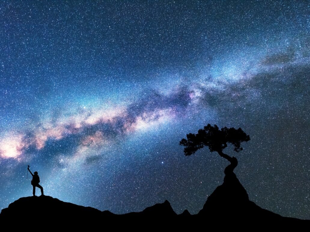 Milky Way, silhouette of woman and tree. Space