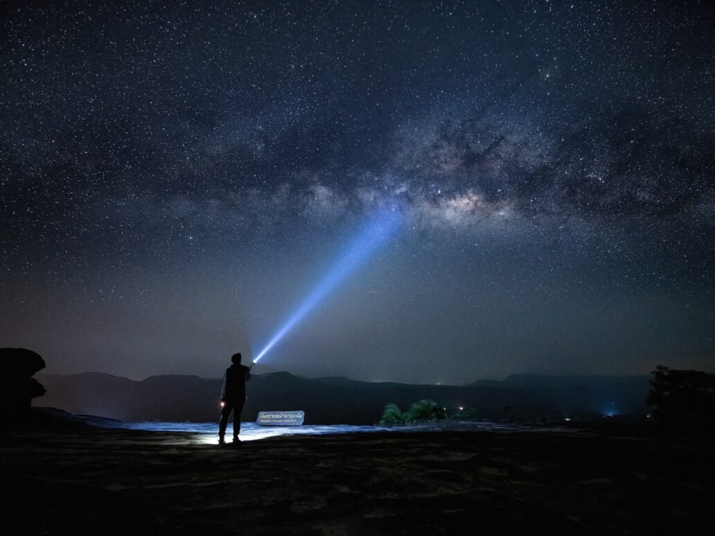 Silhouette traveler hold lighting point to sky with night starry sky milky way is travel and nature